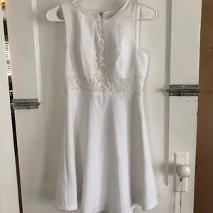 White knee-length dress with floral lace detail